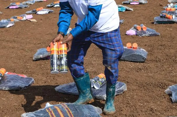A HARO worker lays out relief kits of blankets and mosquito nets for flood-displaced families in Afgooye, 2020