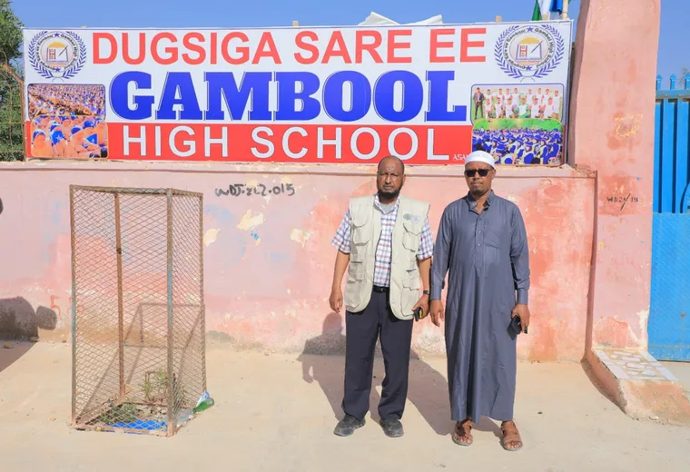 HARO staff outside the gate of Gambool High School, 2023