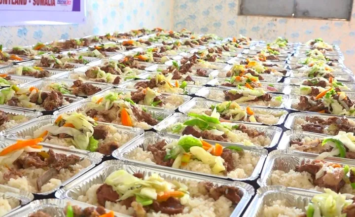 Rows of freshly prepared rice, meat and vegetable meals boxed for a HARO hot-meal distribution in Puntland