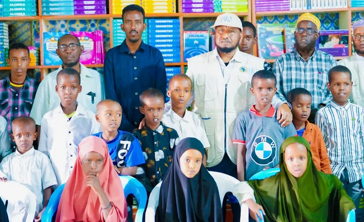 Children with HARO staff in a school library in Somalia