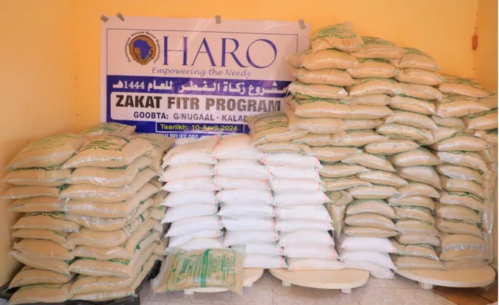Sacks of grain stacked under the HARO Zakat al-Fitr Program banner in Kalabayr, Nugaal, 2024