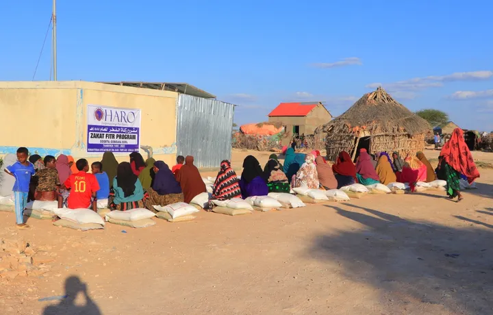 Families seated with sacks of food at the HARO Zakat al-Fitr distribution in Sool region, 2023