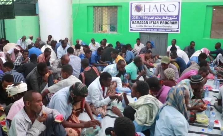 People share an iftar meal served by HARO in Garowe